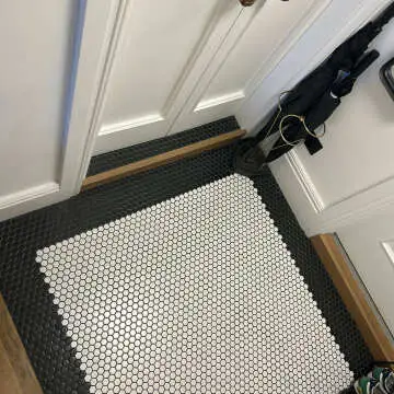 "Using the black and white tiles together in my small entrance hallway makes a striking effect. Small tiles may take longer to lay but the results make it well worth the effort. I love them"