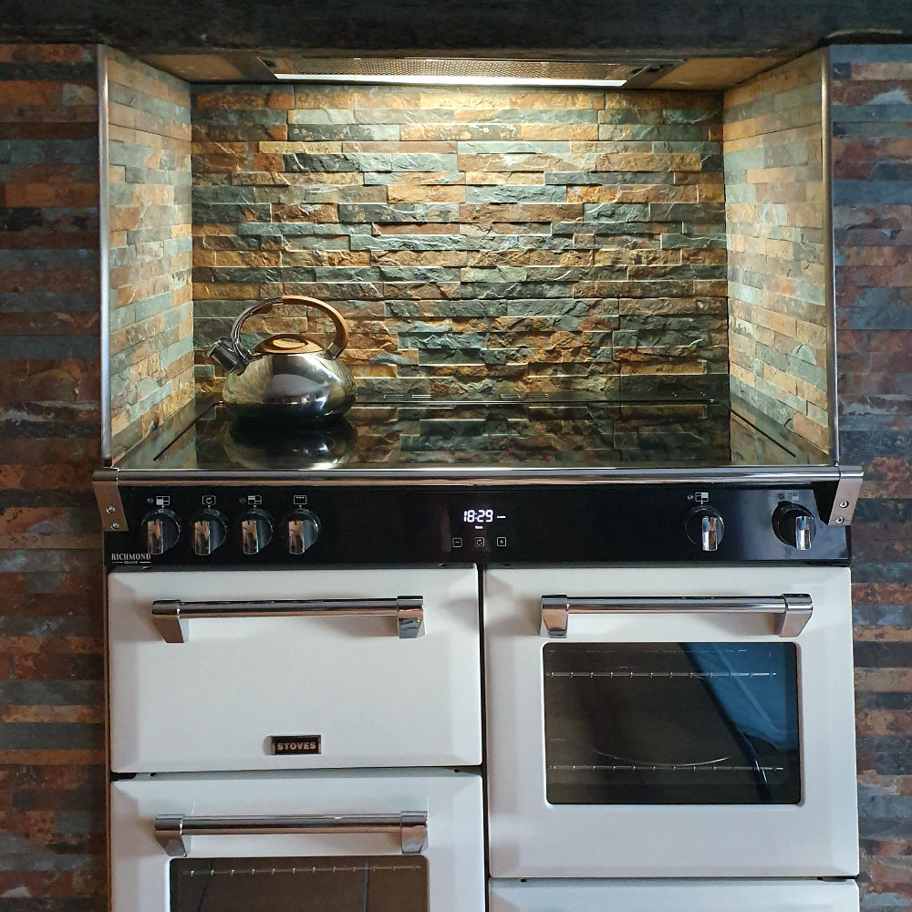Rustic split face effect tiles behind cooker