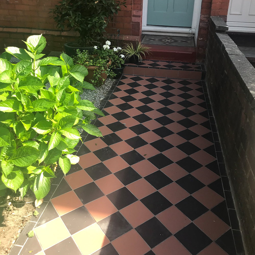 Red and black chequered garden path tiles