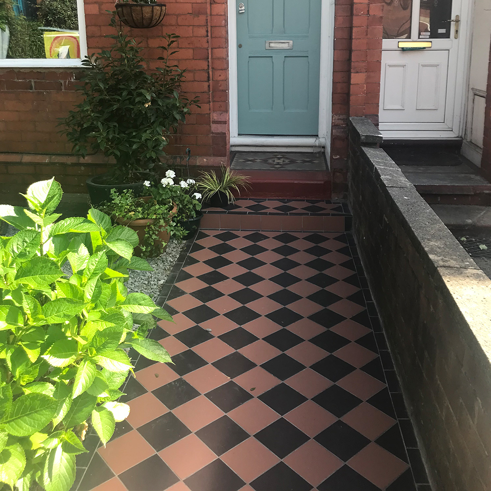 Red and black chequered garden path tiles