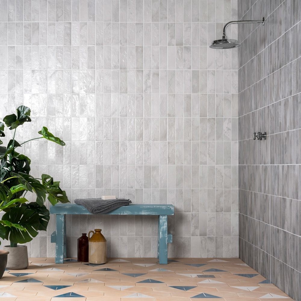 Grey tiled bathroom with plant