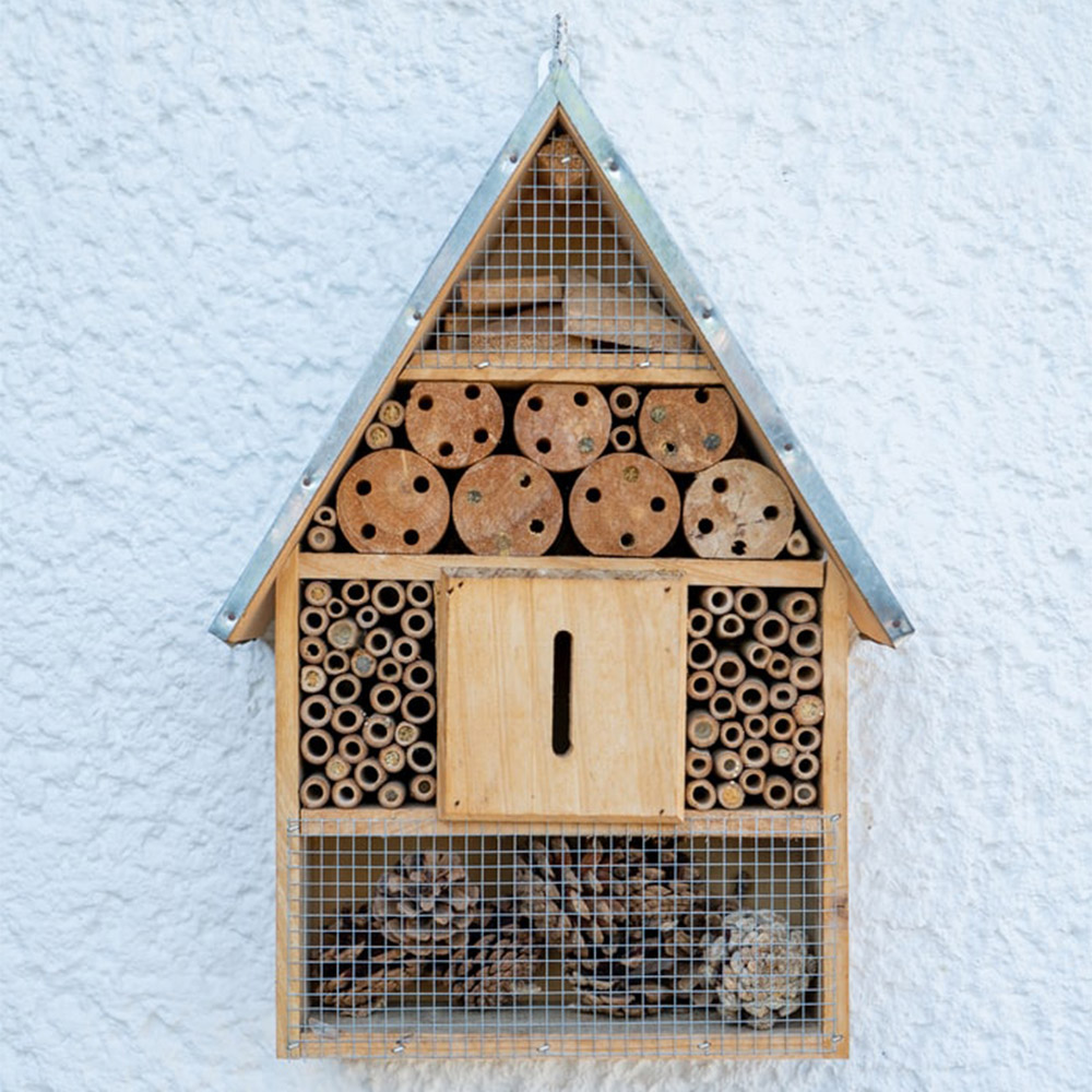 Bee hotel on a white outside wall
