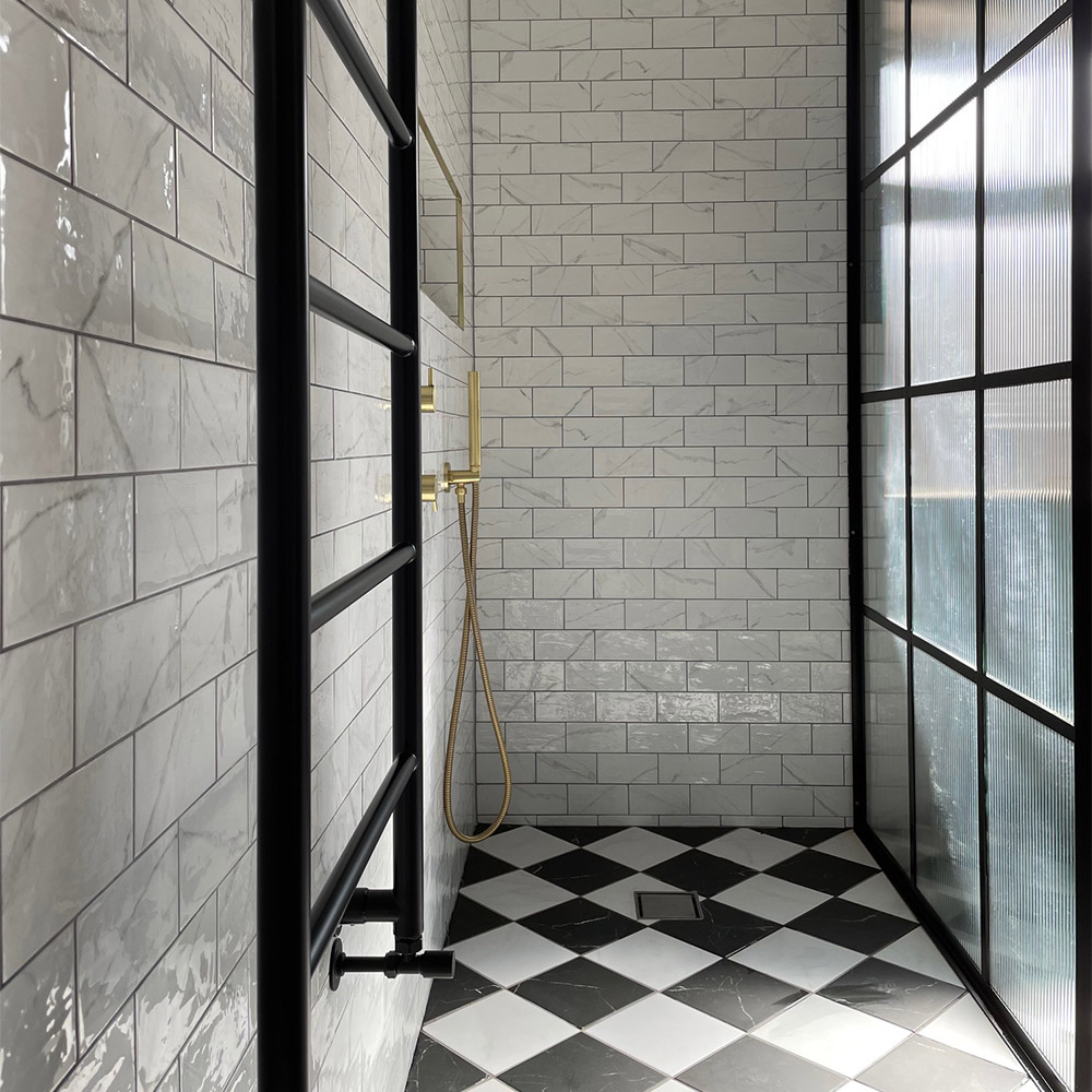 marble checkerboard flooring and white marble wall tiles with contemporary black accents and gold accessories