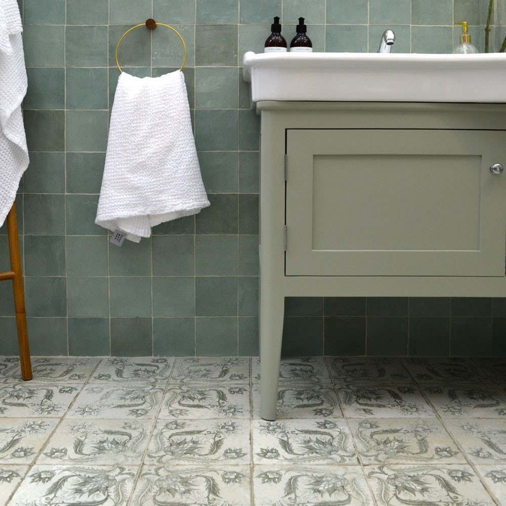green statement tiles on the floor with square green tiles on the wall