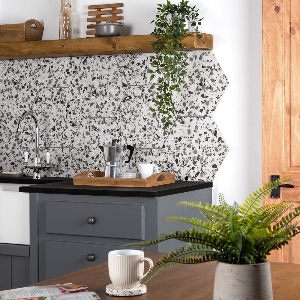 grey speckled hexagon tiles as a splashback in a kitchen