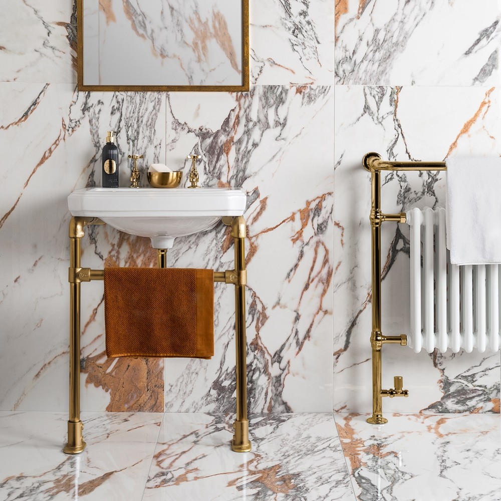 white and gold marble deluxe tiles in a bathroom with gold accents