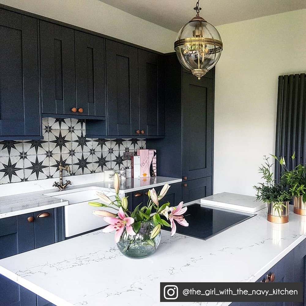 scintilla star tiles in a navy kitchen as a splashback 