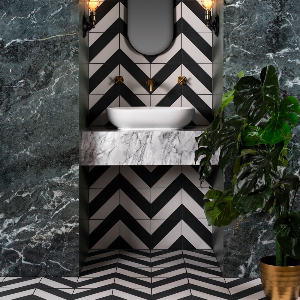 black and white zebra tiles in a chevron pattern on the walls and floors