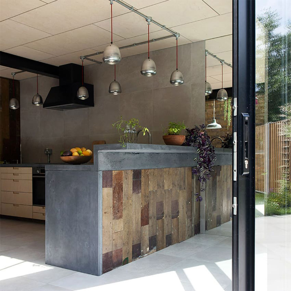 Industial style kitchen with trax grey mist stone effect porcelain paving slabs indoors outdoors look