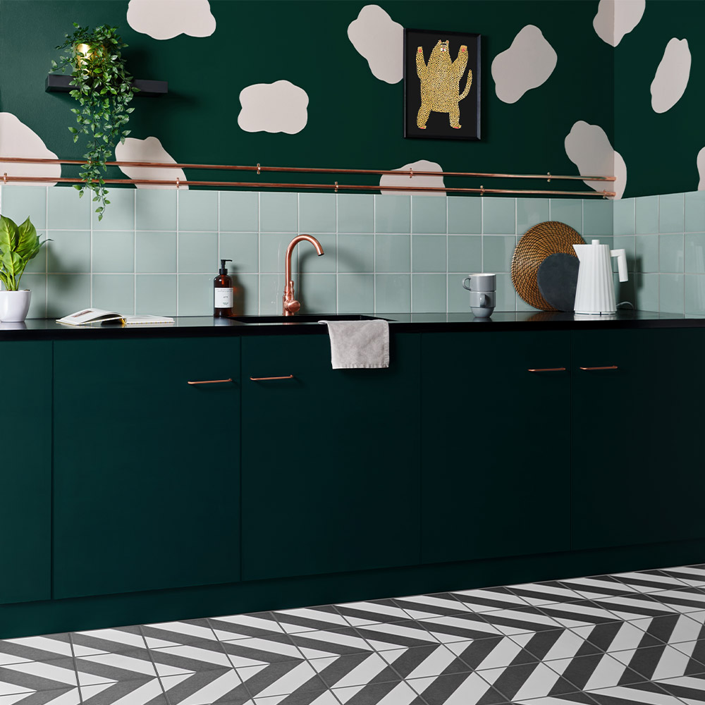 Pistachio pick n mix tile with cloud like patterns on the walls and zebra patterned striped black and white tiles on the floor