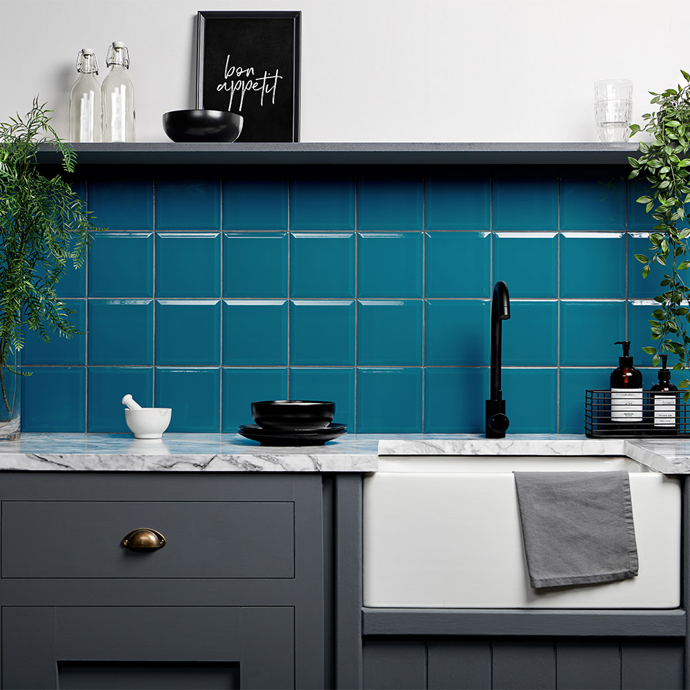 Capsule bright blue ceramic kalami bay square tiles in contrasted display with white painted walls and white grey marble counter top