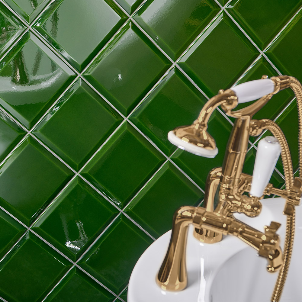 Capsule Victorian green square ceramic tiles with bevelled edges and a deep translucent glaze with a puddle effect with a gold and white traditional Victorian style bath and shower tap