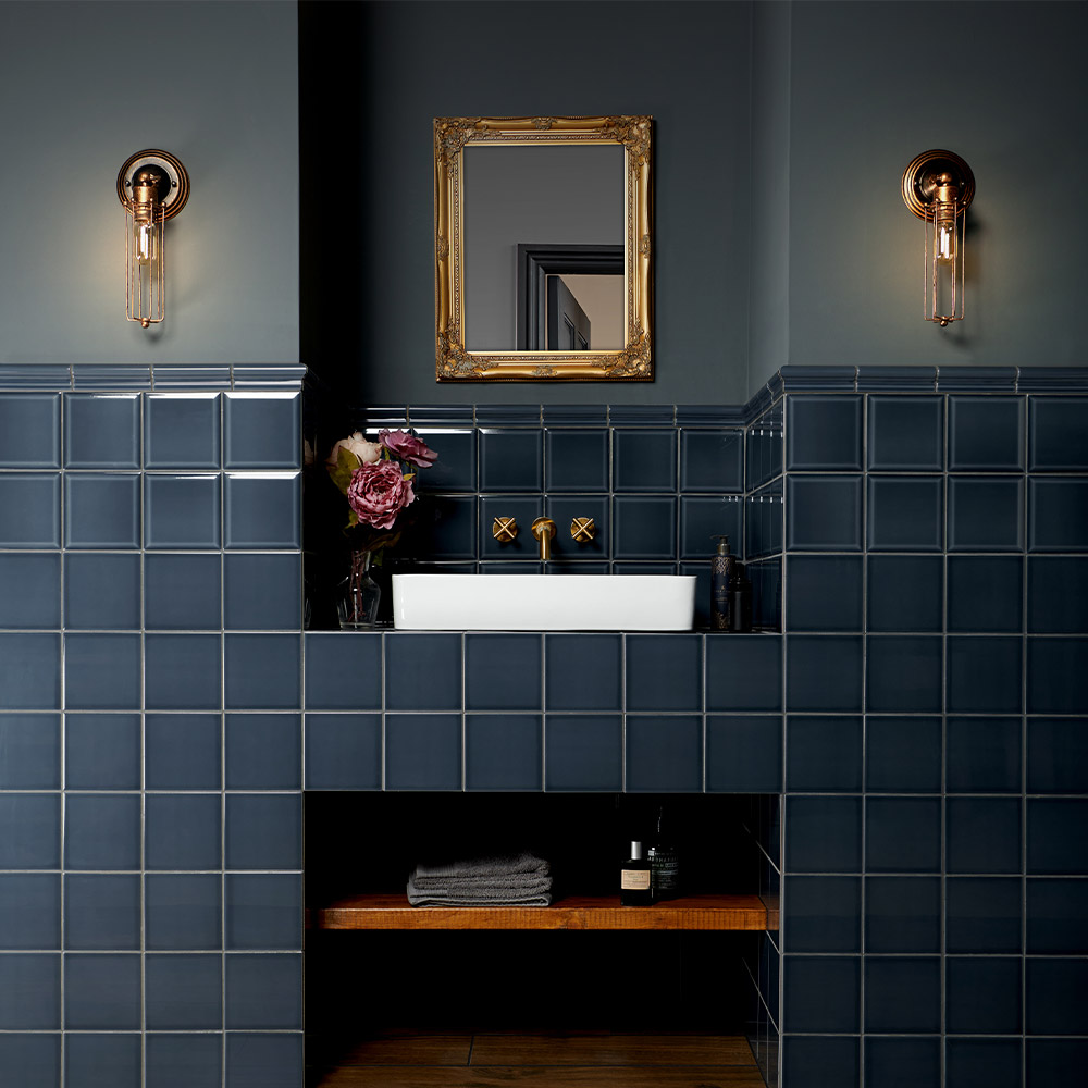 Capsule inked dark blue tiles with bevelled edges and deep translucent glaze paired with blue painted walls for a monochromatic look