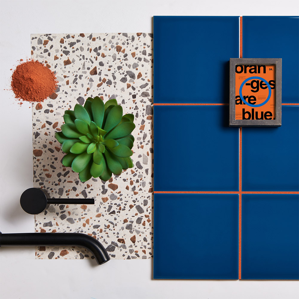 Pick n mix blueberry square ceramic square tiles with orange grout paired with terrazzo print 