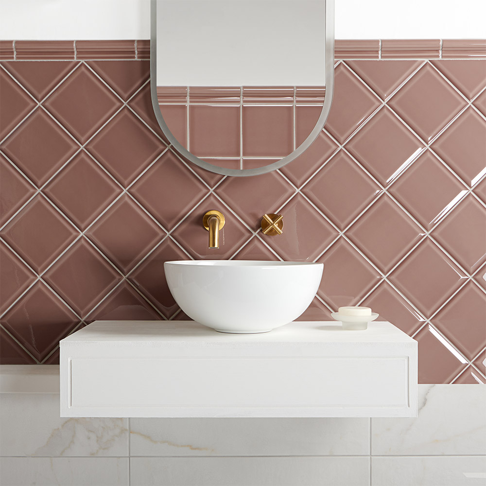 Capsule powder room dusky pink square ceramic tiles with bevelled edge and deep translucent glaze in puddle effect