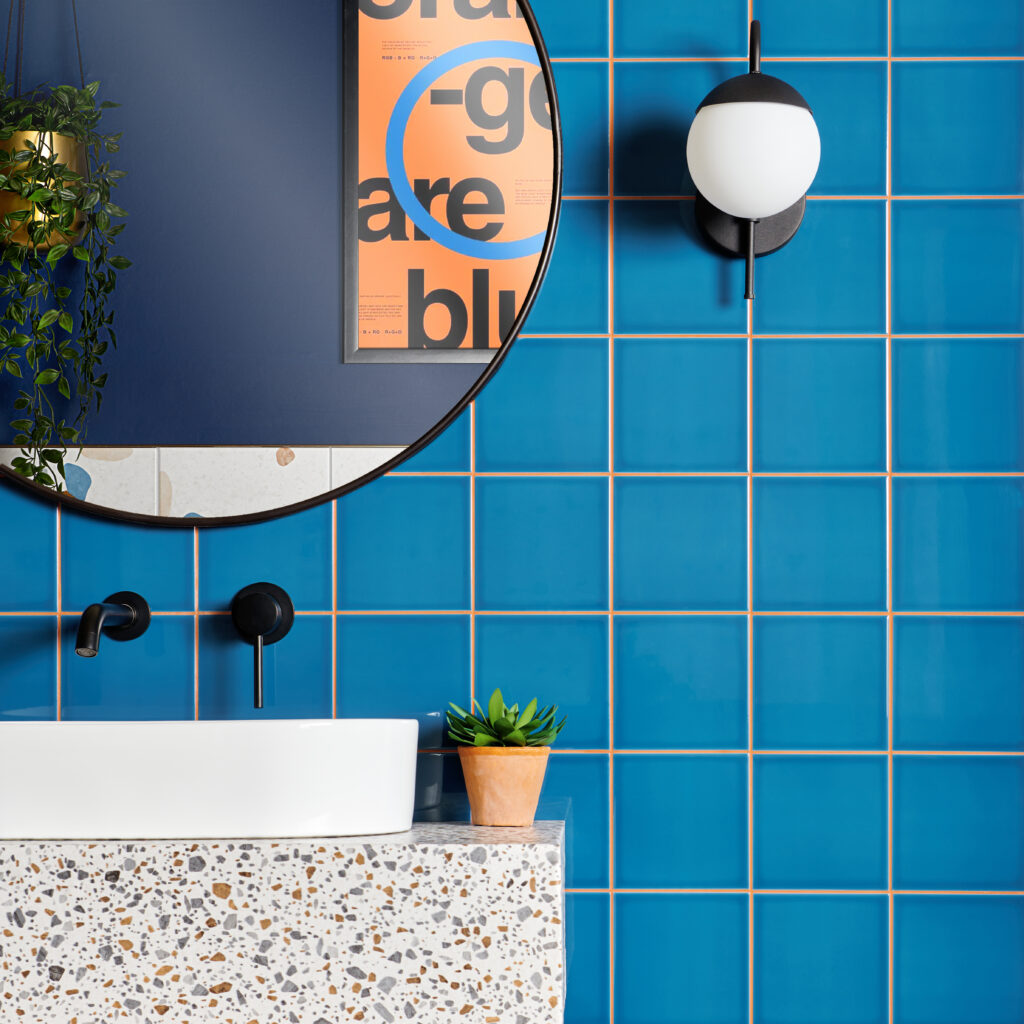 Pick n mix blueberry square ceramic tiles with orange grout and a terrazzo style sink