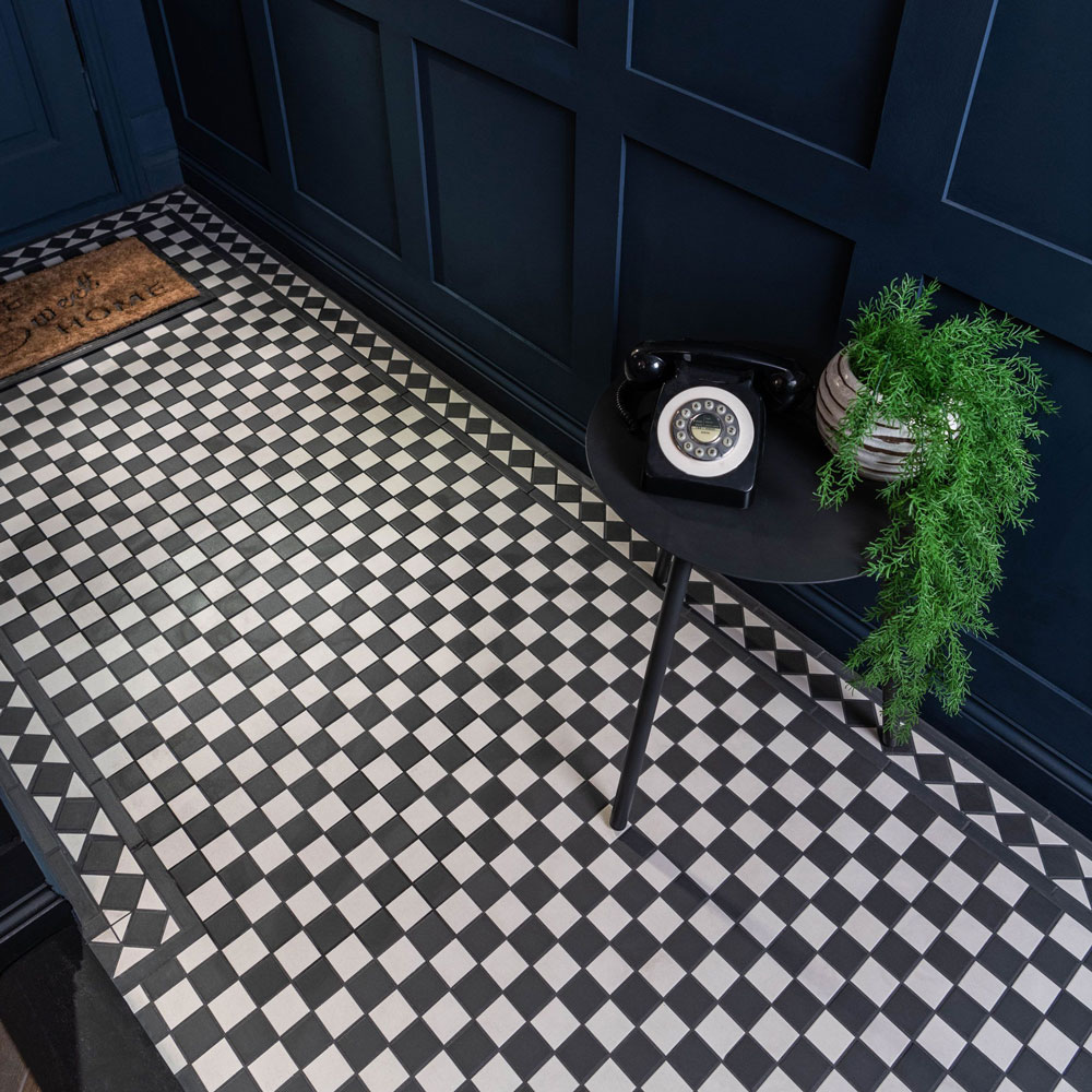 Black and white small chequer flooring in hallways with navy blue walls.