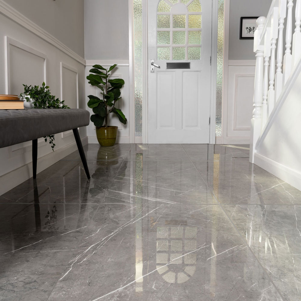 Shiny grey marble flooring with white accents.