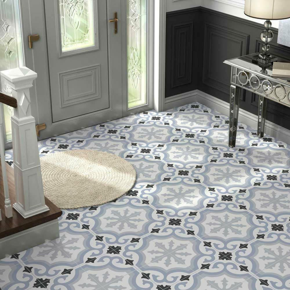 Light blue, white and black patterned floor tiles with white pieces throughout the hallway.