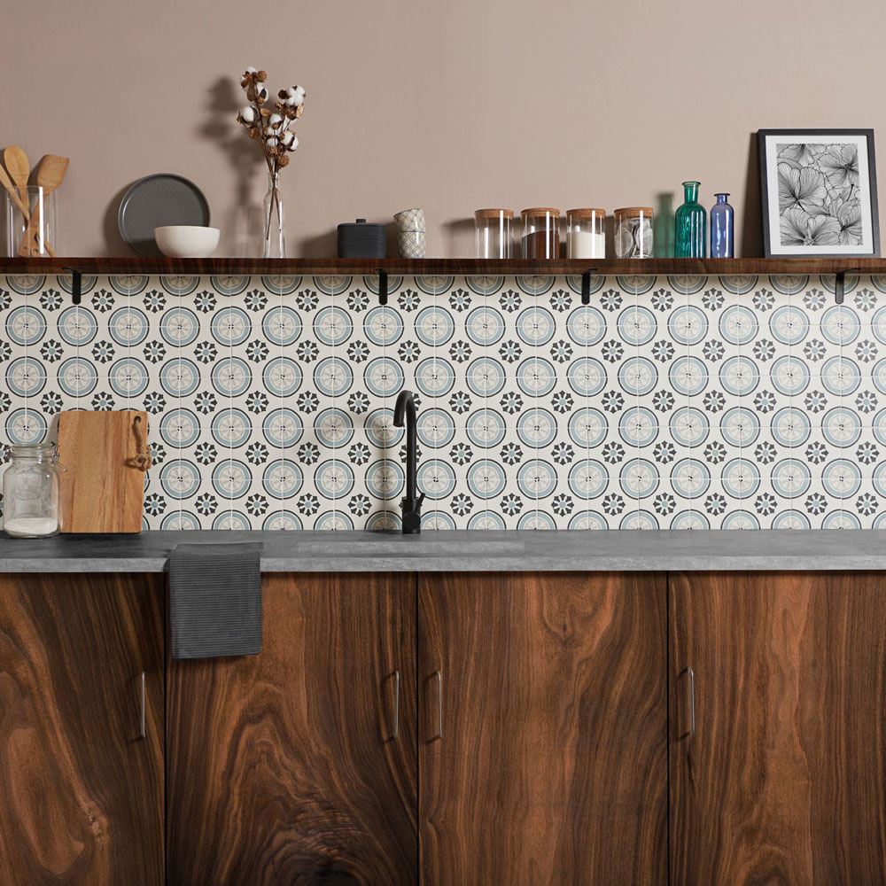 Kitchen splashback idea is patterned tile against a wooden cabinet.