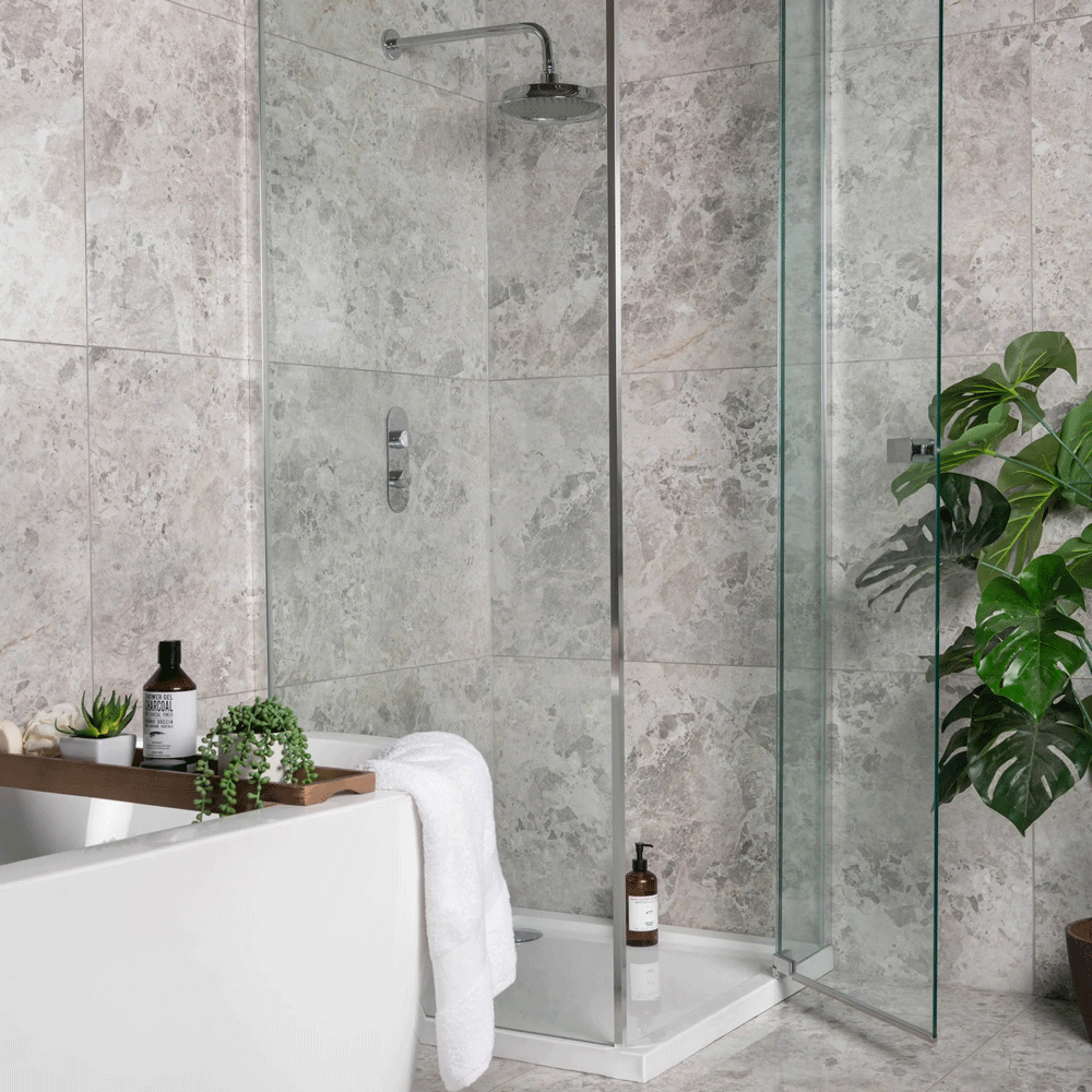 Grey stone effect tiles throughout shower area with plenty of greenery and elegant accessories. 