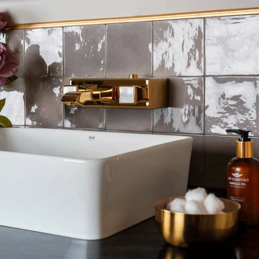 Gold hardware used throughout whole sink area with classy accessories. 