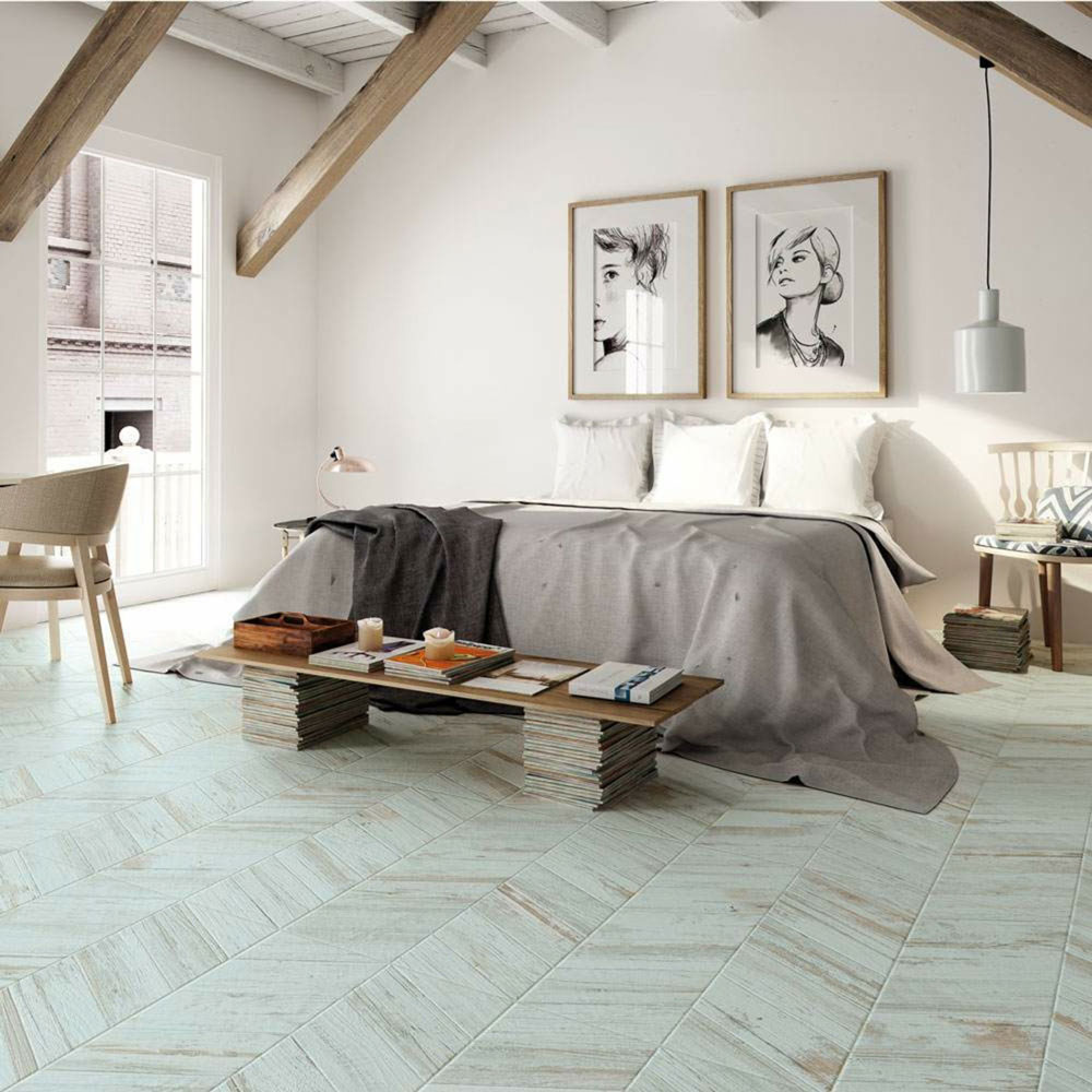 Rustic blue wood effect floor tiles in bedroom scheme with neutral tones throughout the rest of the space. 
