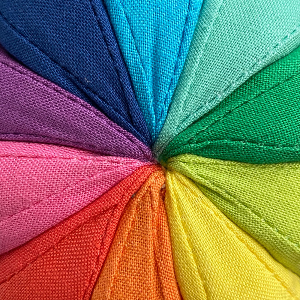 Vibrant rainbow colour wheel made with material.