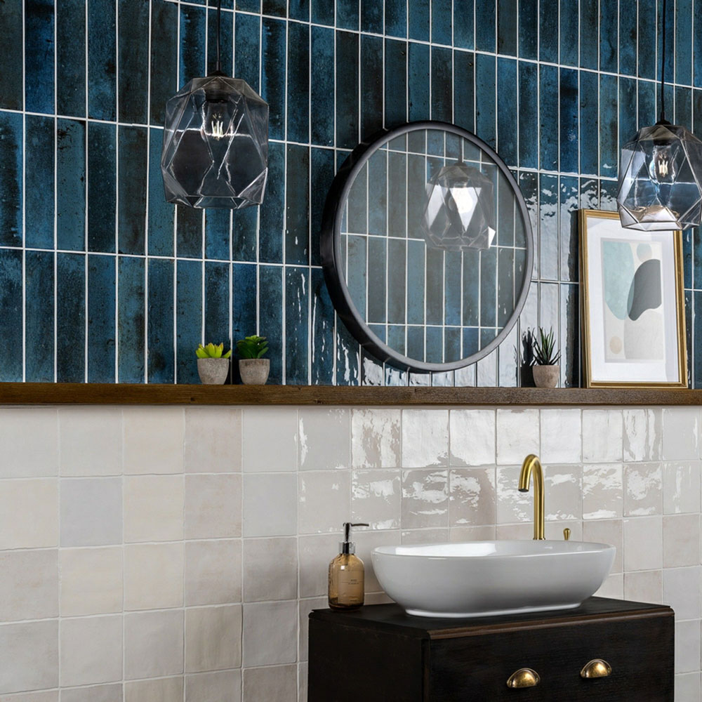 Deep blue multi tonal brick wall tiles in bathroom scheme with rustic white square tiles to complement. 