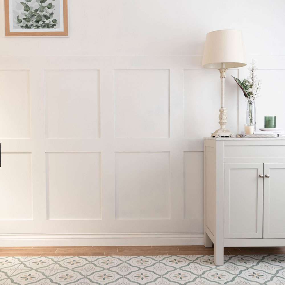 Pure white paint on panelling in bedroom scheme with wood tiles and patterned tiles across floor space. 