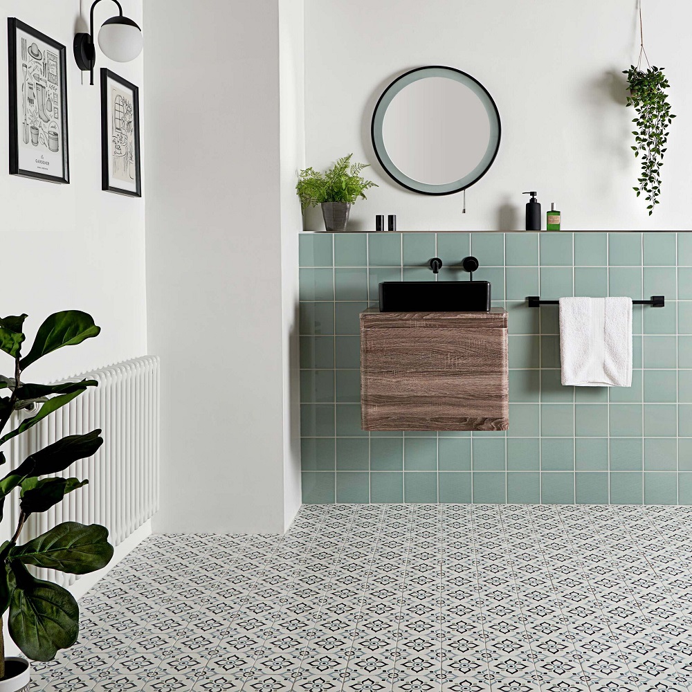 Moroccan bathroom floor tile with mint square tile across the walls of vanity area, with modern black accessories. 