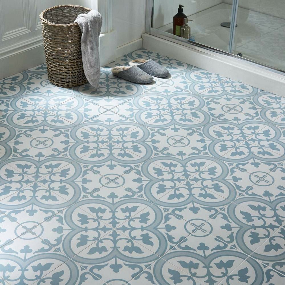 Blue and white patterned tile across shower area of Moroccan style bathroom. 