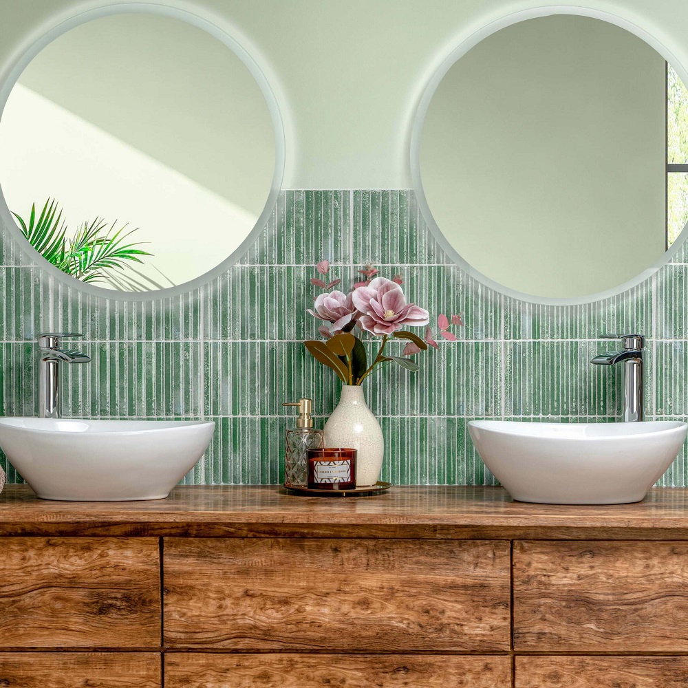 Green bathroom scheme using Meraki Kitt-Kat Turquoise, with warm wood unit and pink flowers to style the space. 