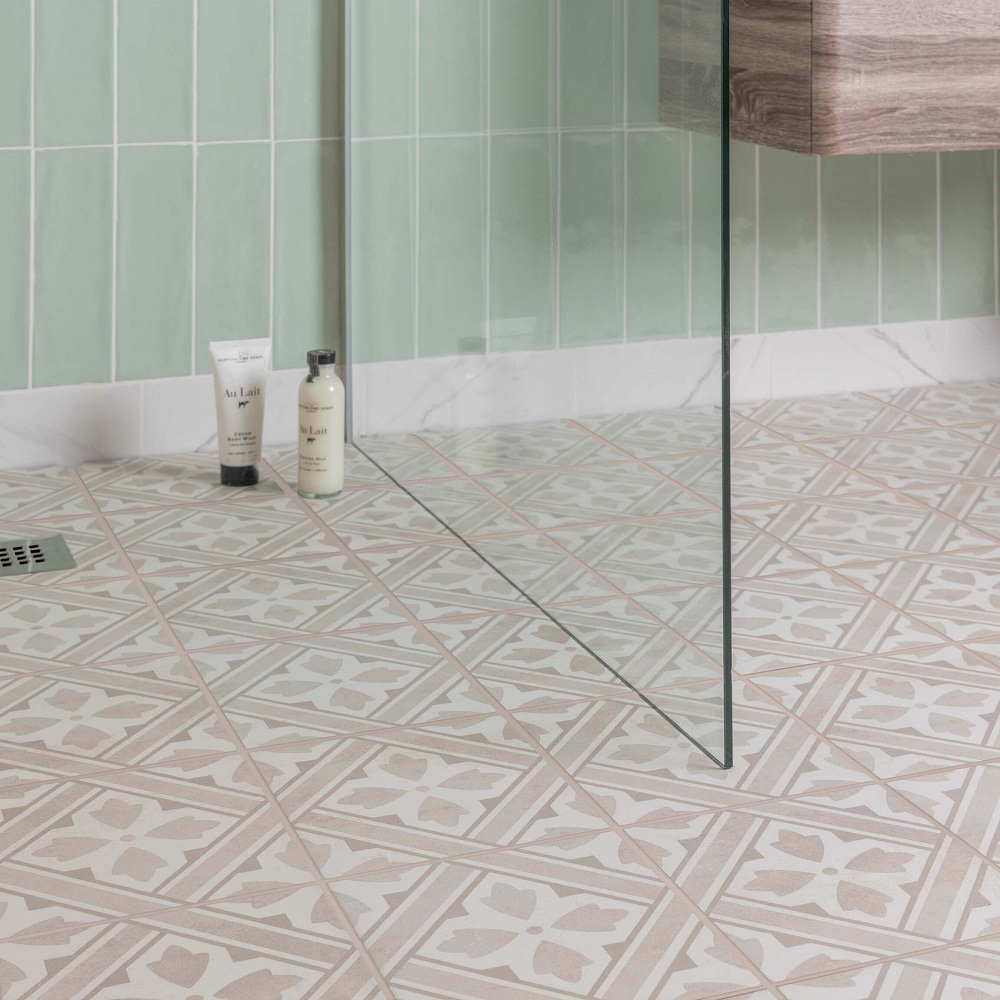 Complimentary grout colour to match patterned traditional style tiles across floor of shower area. 