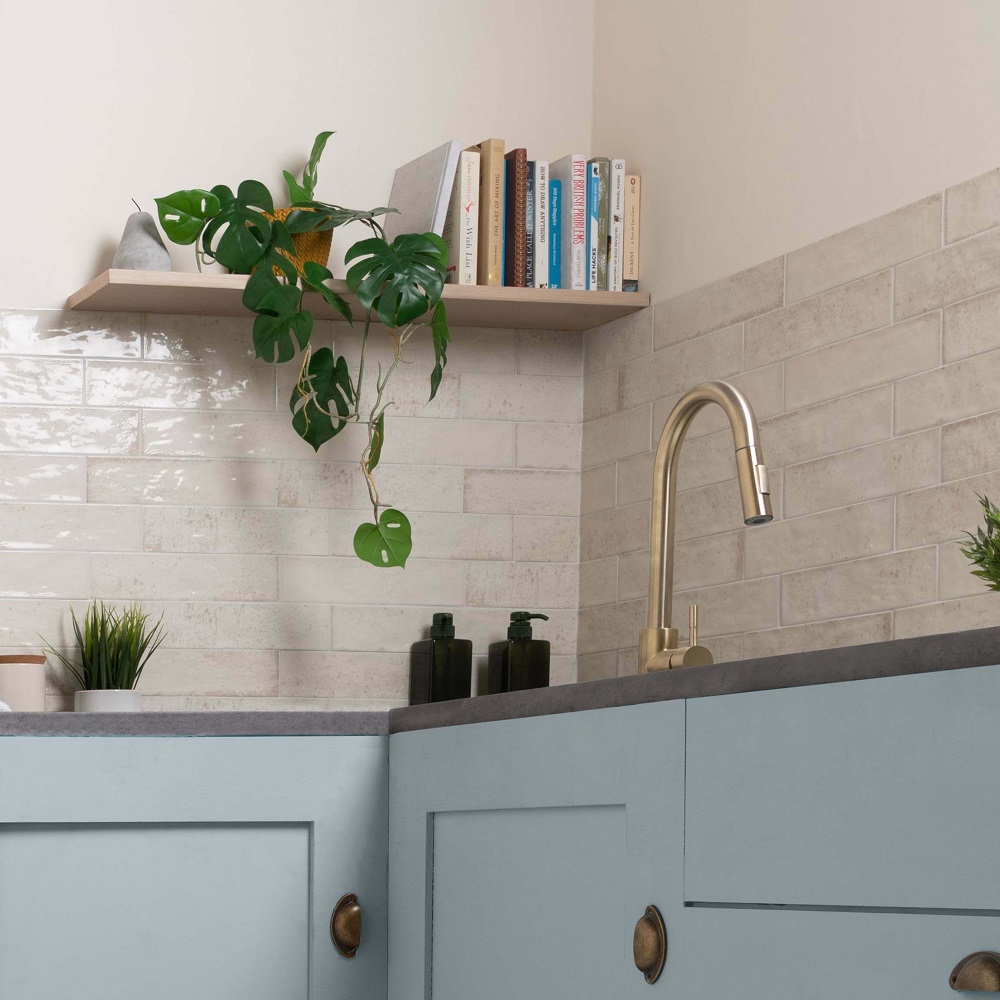 Ivory brick wall tiles across kitchen splashback with pastel blue cabinets.