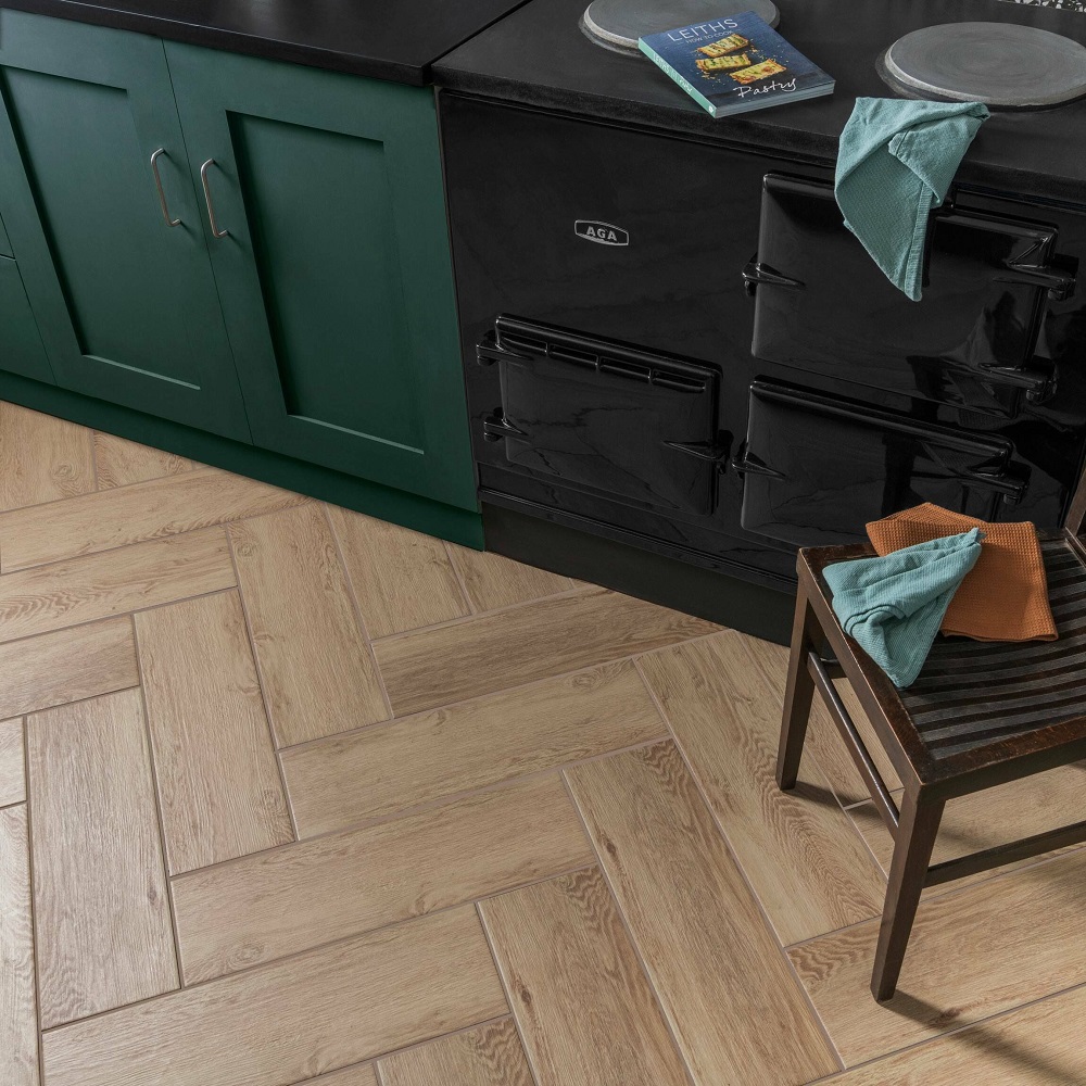 Light wood effect tiles across kitchen floor with grout colour that blends in seamlessly. 