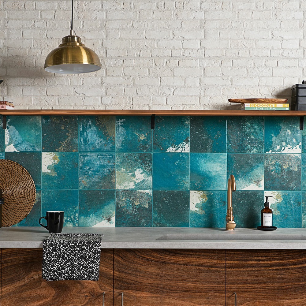 Square small tile size across splashback with striking blue design and dark wood cabinets. 