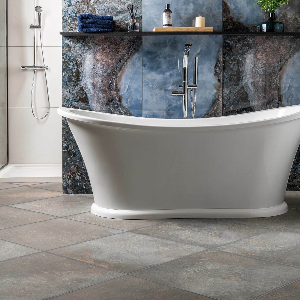 Large square tile size in diagonal format across floors of luxurious bathroom with large format onyx marble tiles across walls and white traditional freestanding bath. 