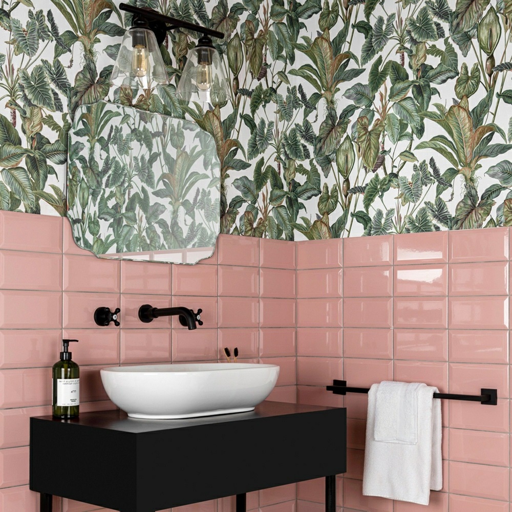 Vibrant pink splashback in bathroom with tropical leaf wallpaper above splashback, black bathroom accents run throughout bathroom.
