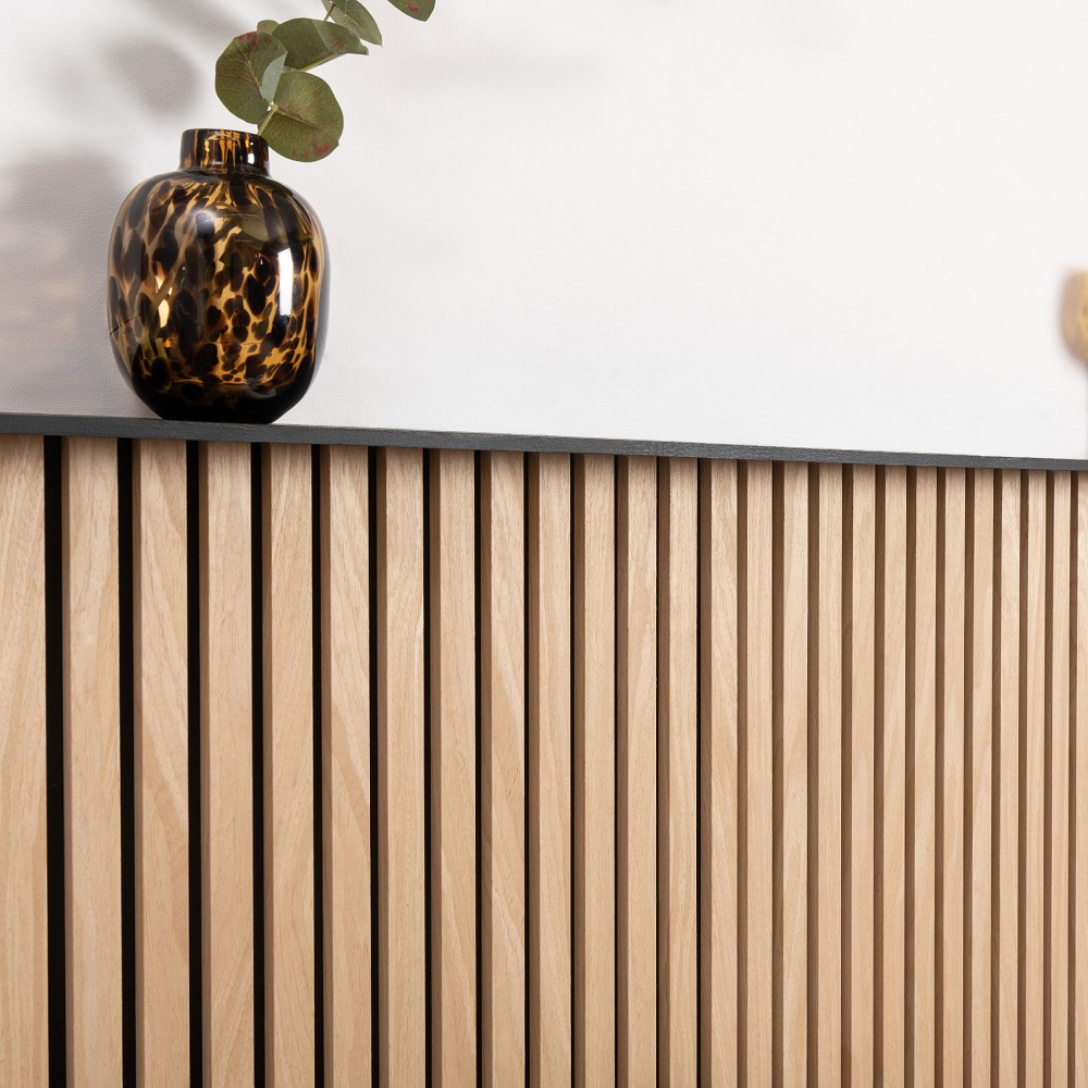 Close up of mini wood slat wall panels with modern vase on shelf.