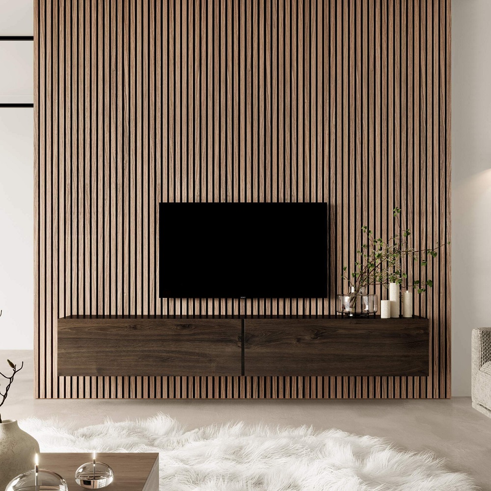 Sophisticated and streamlined living room design featuring a sleek, wall-mounted television against a textured vertical wood slat wall panel in rich autum brown. Below the TV, a matching walnut floating console adds a touch of elegance, adorned with simple, chic decor including a clear vase with greenery and minimalist white candles. The room's modern aesthetic is completed with a luxurious white faux fur rug, creating a warm, inviting space that marries style with comfort. 