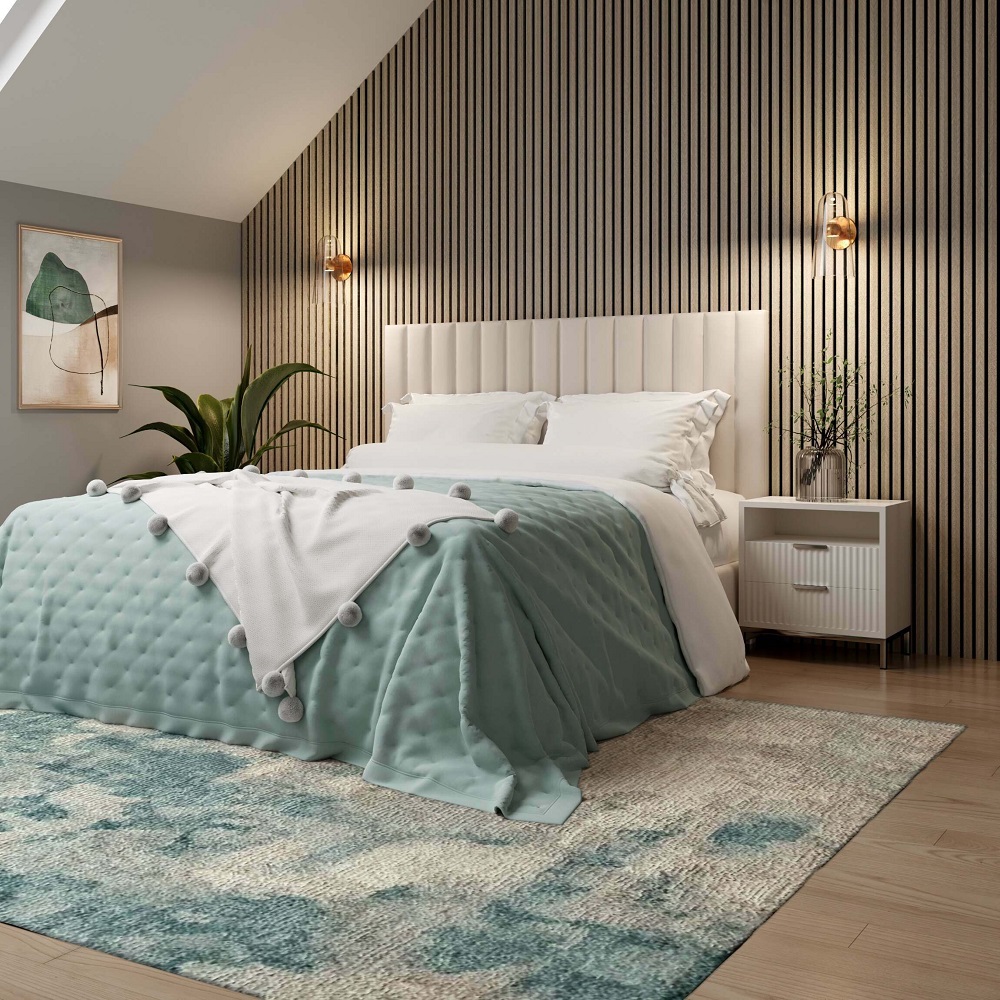 Chic bedroom showcasing style with wood wall panels, featuring a cosy bed adorned with crisp white sheets and a seafoam green blue quilt with playful pom poms, complemented by a soft textured rug and elegant side lighting, creating a tranquil and modern space. 